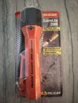 New Pelican Brand Nos Sabrelite 2000C Orange Flashlight Still Sealed/packaged. Fixed Price $14.00.